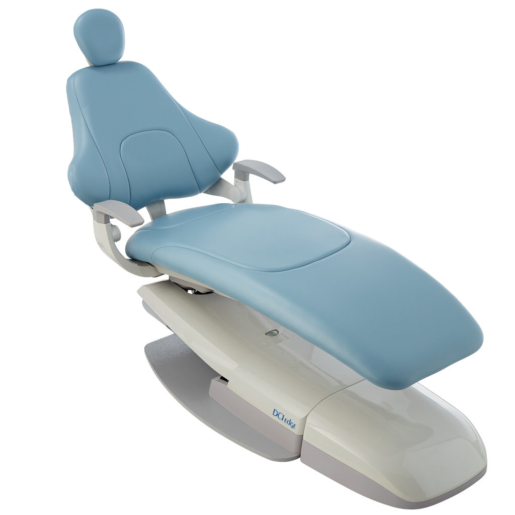 Blue reclining dental chair with padded headrest and adjustable armrests on a white background.