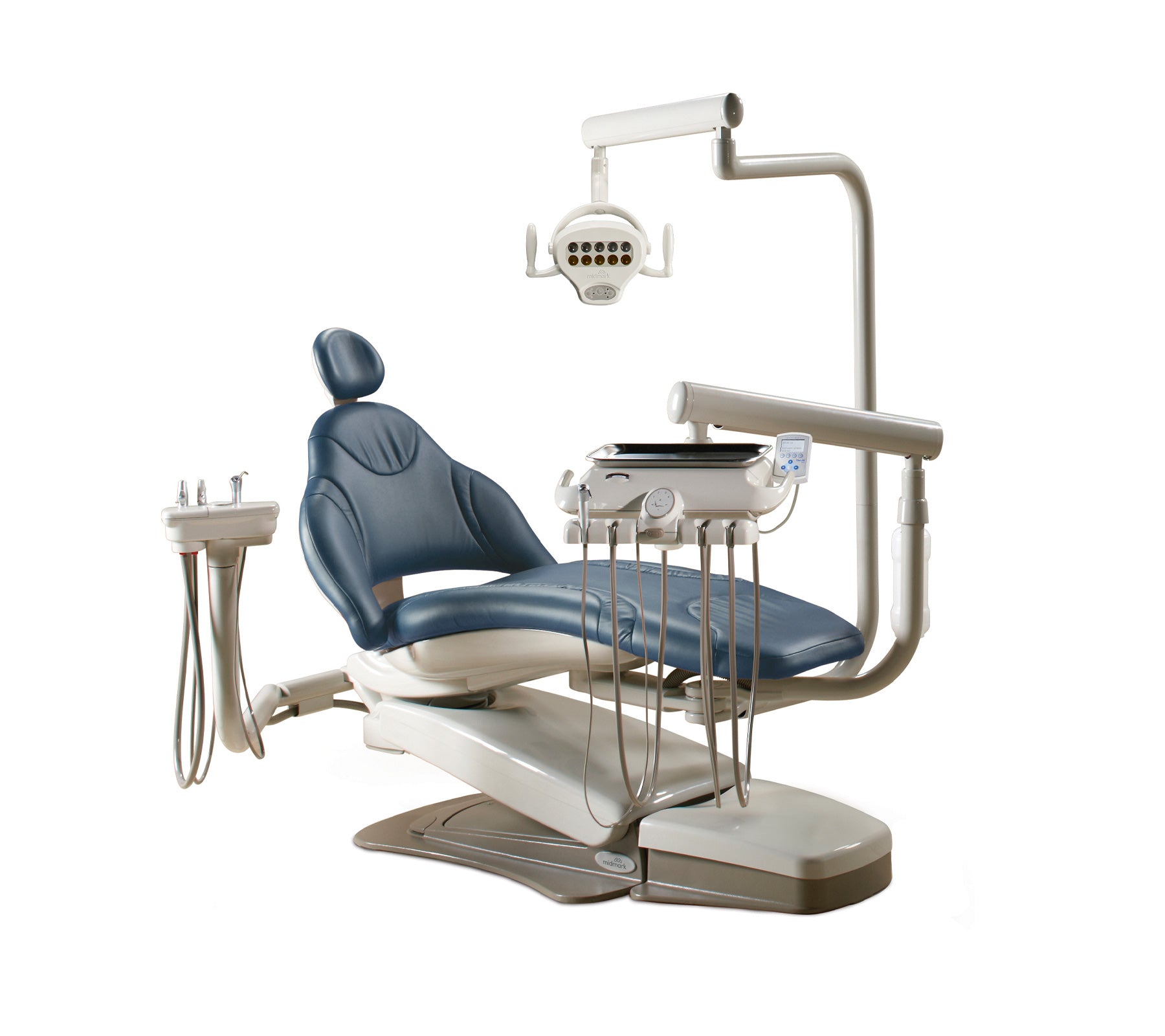 Dental chair with overhead light, instrument delivery system and patient seat on a white background.