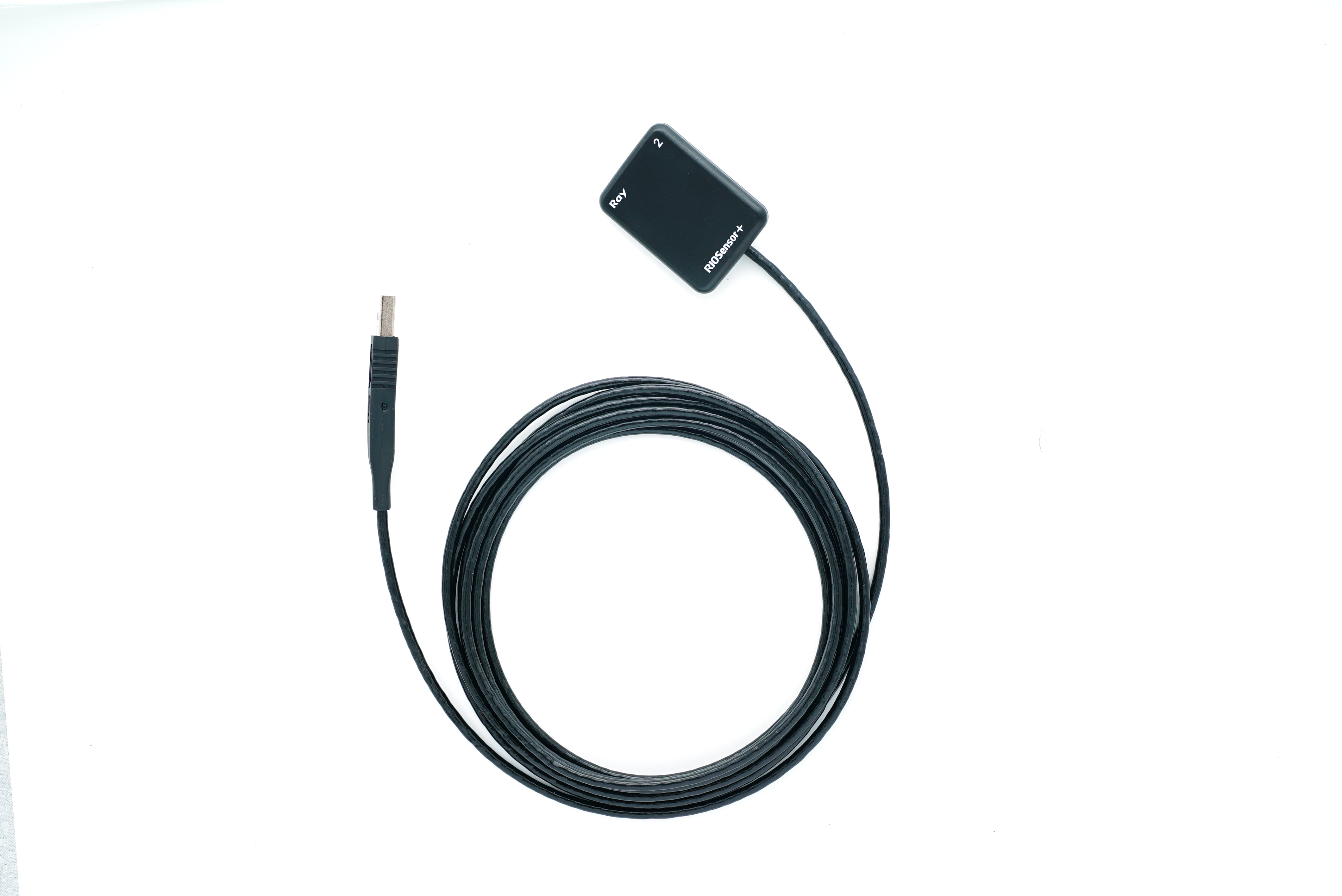 Black intraoral camera cable with USB connector and sensor module coiled on a white background.